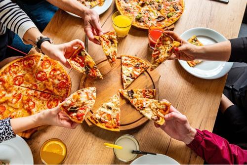 A group of people having pizza