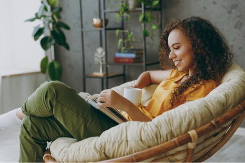Girl reading book on a couch